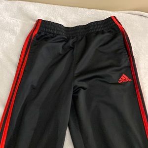 Black and red adidas track pants